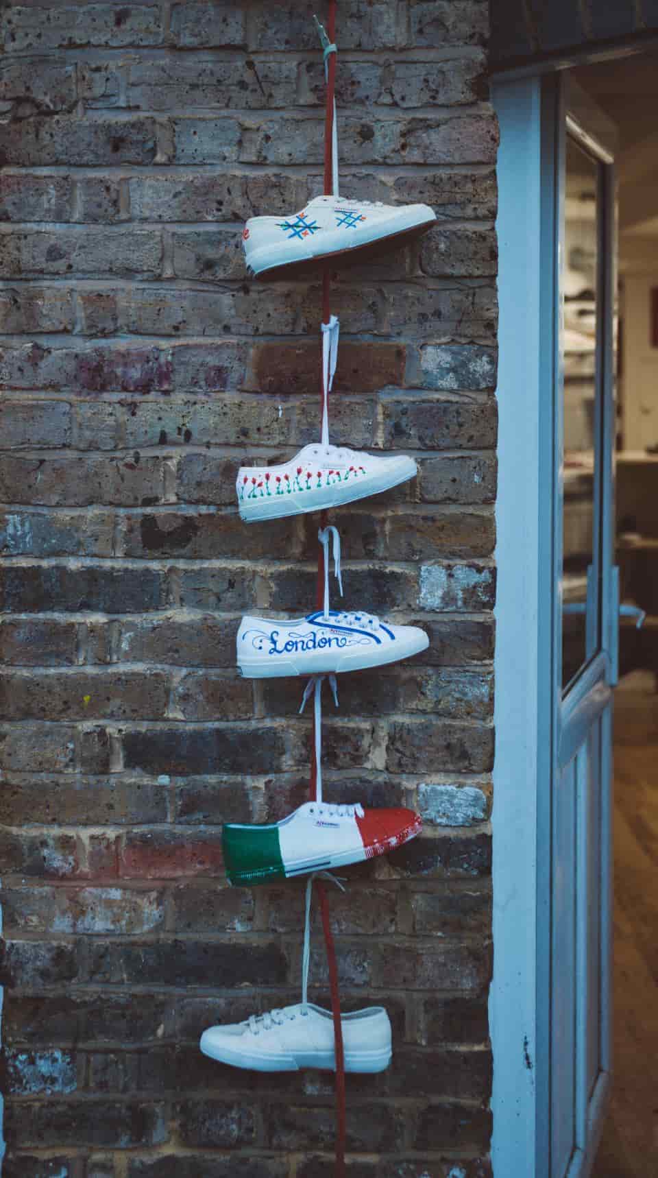 A wide, rounded minimalist shoe beside a packed-flat boot