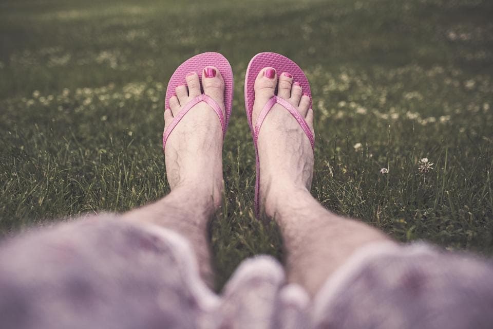 A thin rubber thong sandal beside a strapped minimal sandal