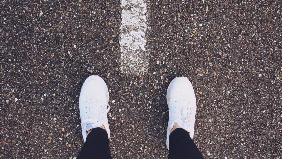 A pair of women's minimalist shoes on a tiled floor