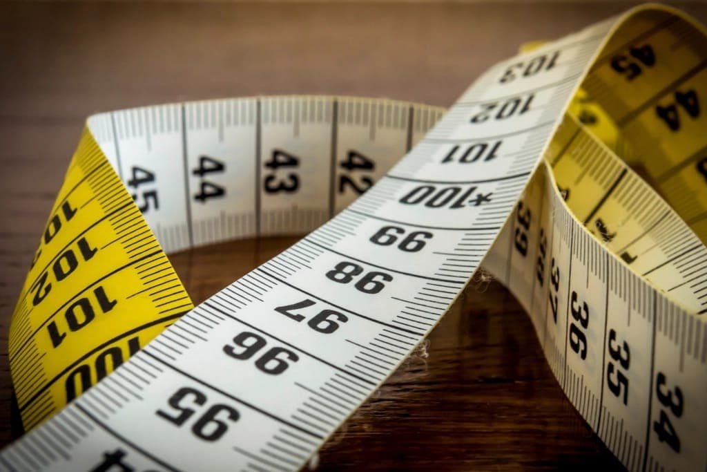 A foot being measured against a printed length chart