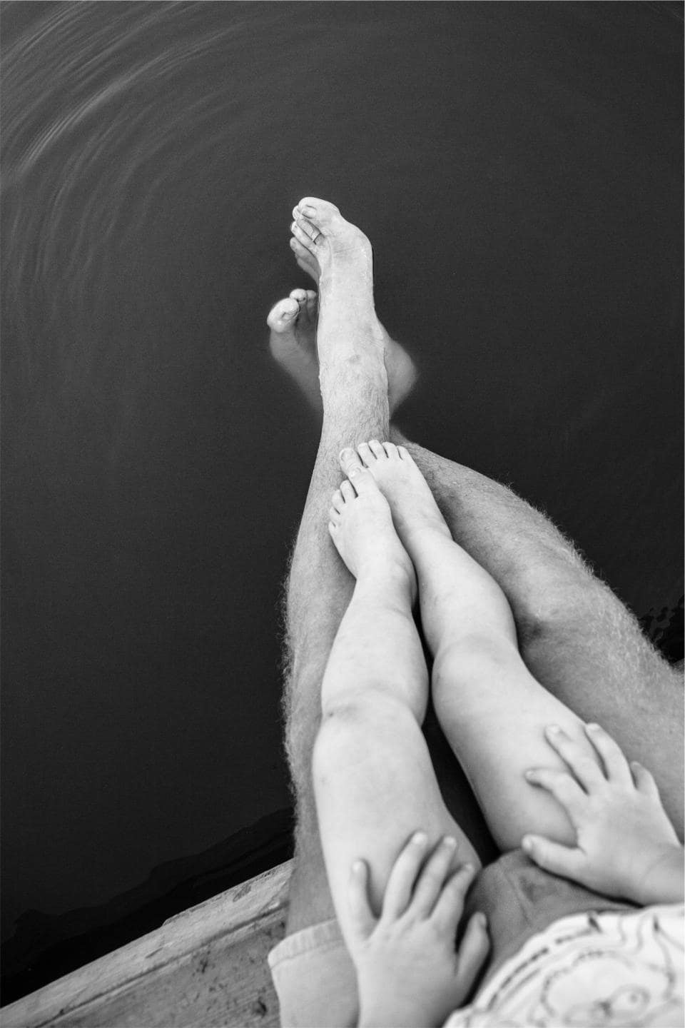 Silicone toe spacers positioned between the toes of a bare foot