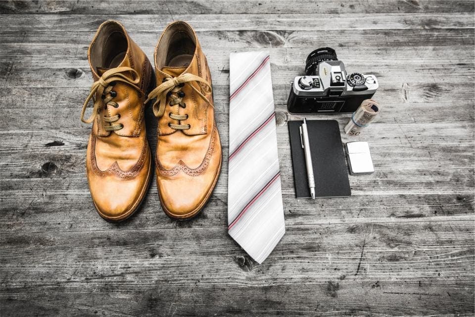 A thin minimalist shoe beside a thickly cushioned zero-drop shoe