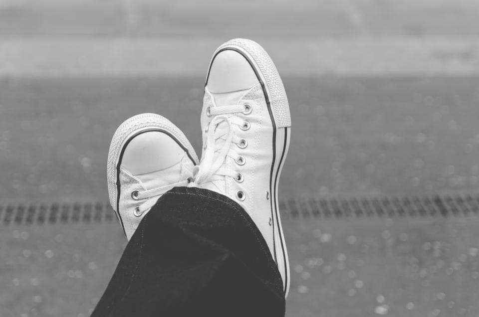 A slim leather minimalist sneaker against a plain background