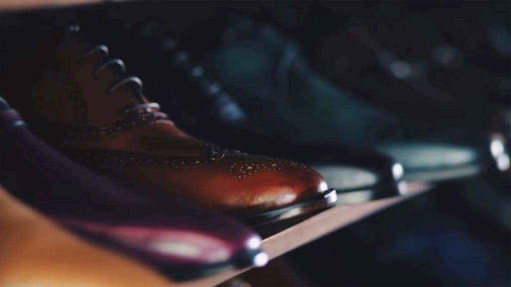 A sturdy leather boot with a reinforced toe on farm ground