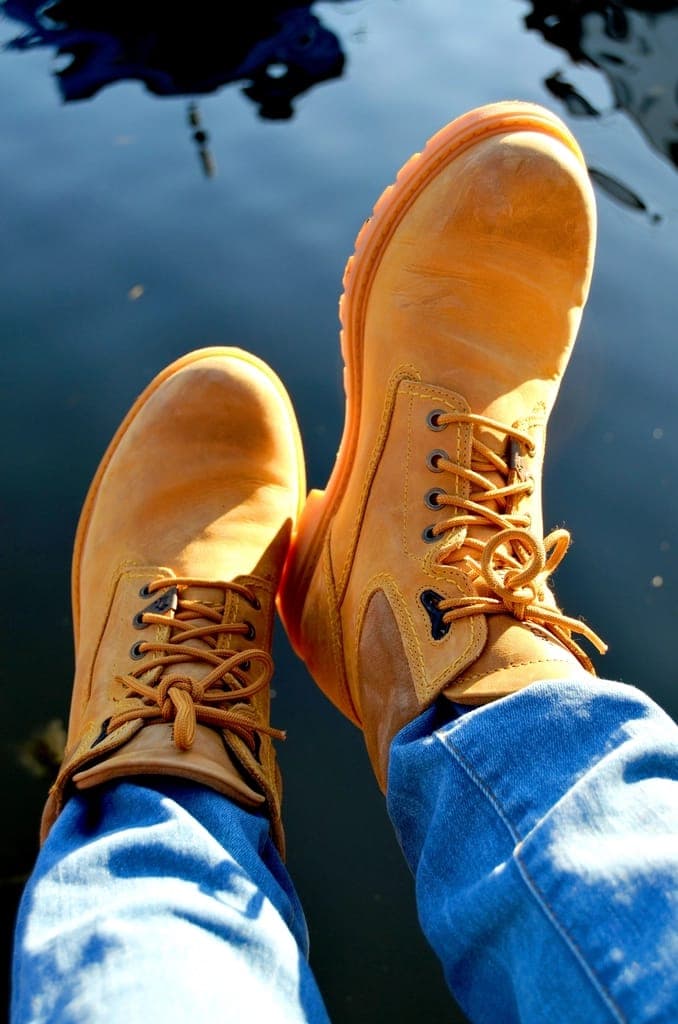 A work boot standing on a bare concrete floor