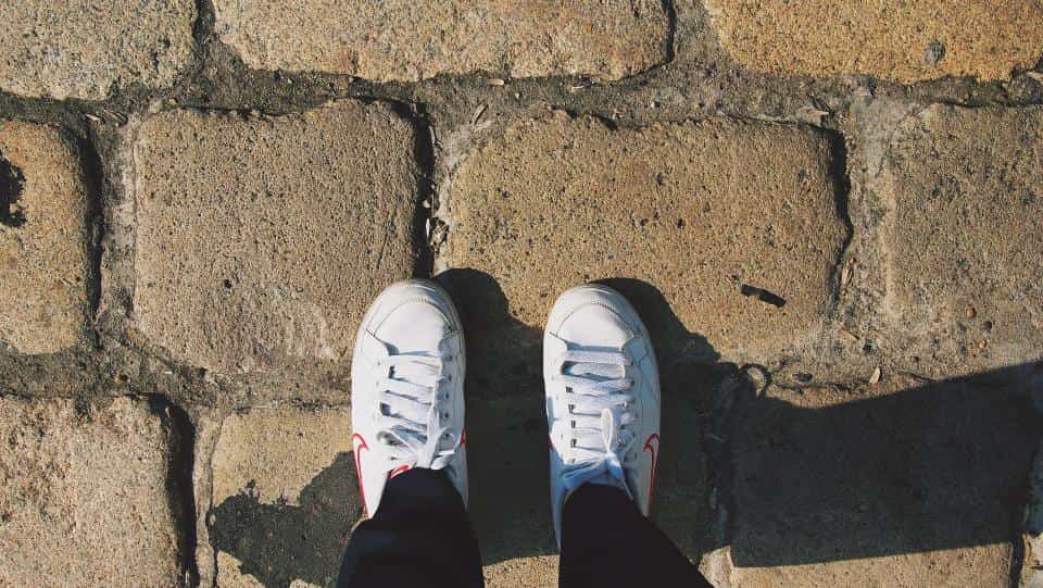 A low-cut safety trainer on a warehouse floor