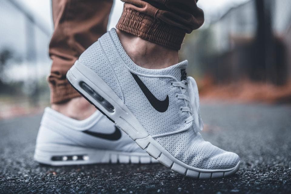 A flexible zero-drop mesh sneaker rolled to show a thin, bendable sole
