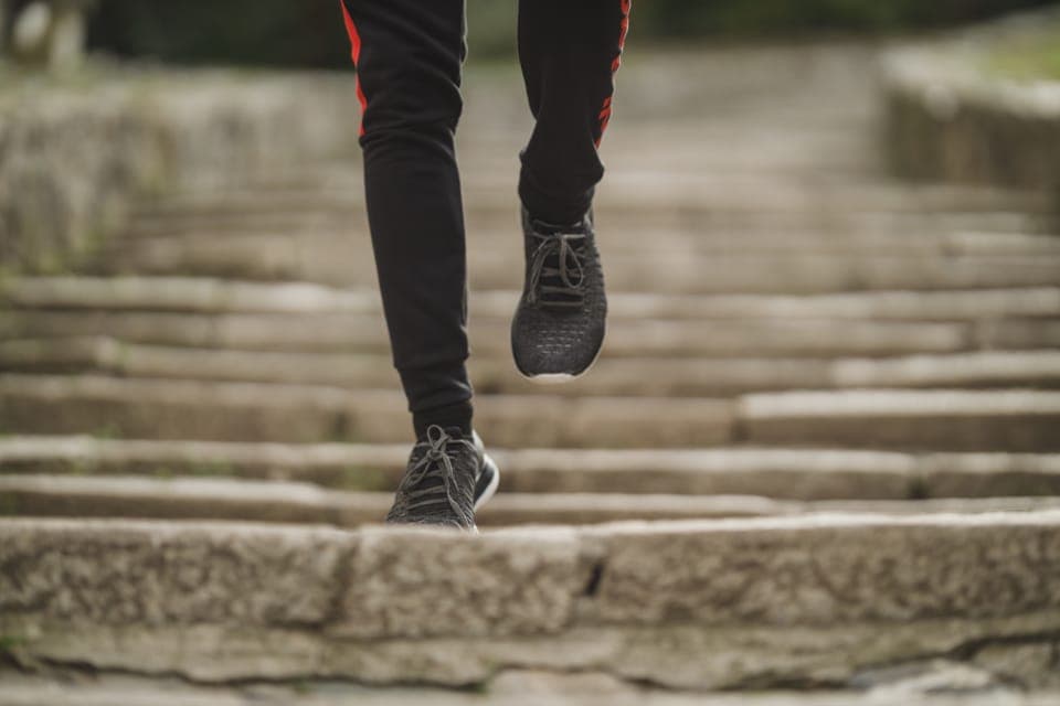 A new pair of minimal running shoes beside a treadmill