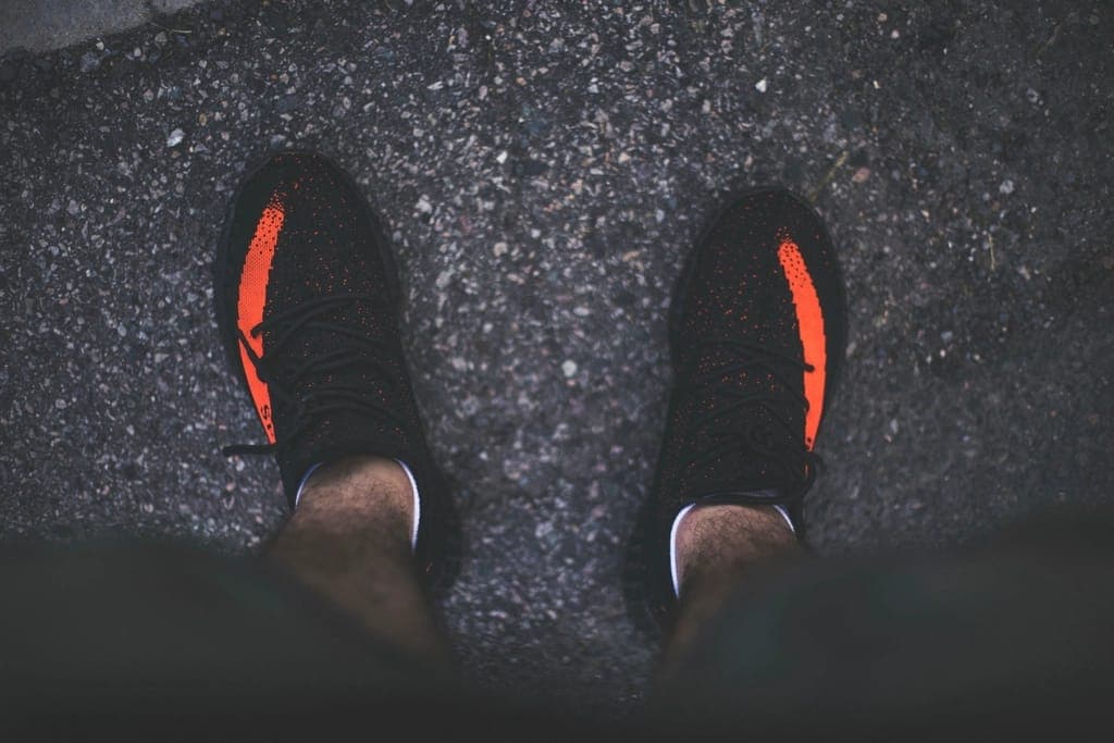 A thick-soled maximalist running shoe beside a thin minimalist one